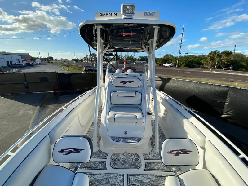 Slide: The Image of 2020 Glasstream 280 Pro-XS boat interior with Garmin equipment, white seating, and open deck. - 36