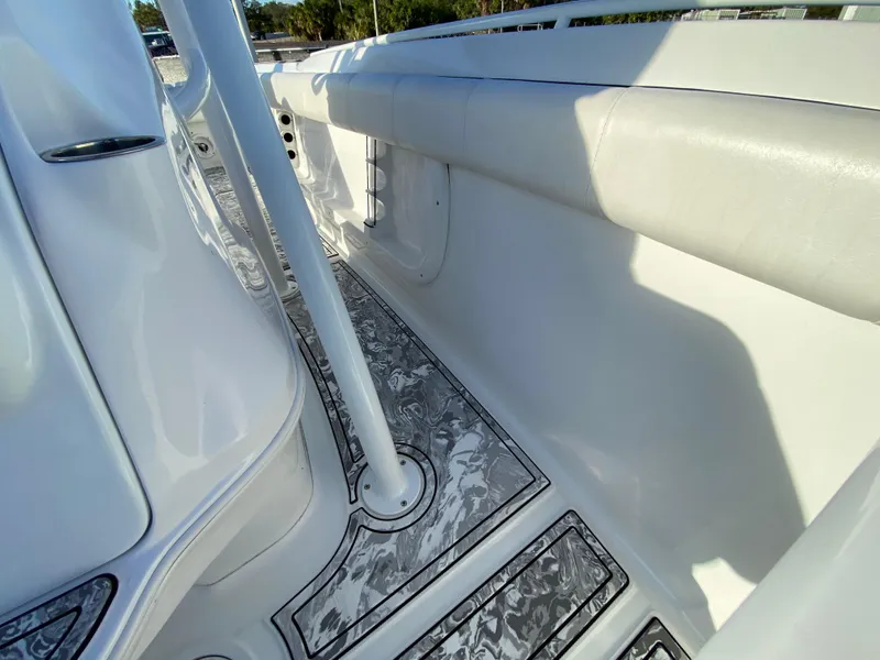 Slide: The Image of 2020 Glasstream 280 Pro-XS boat interior with cushioned seating and patterned flooring. - 42