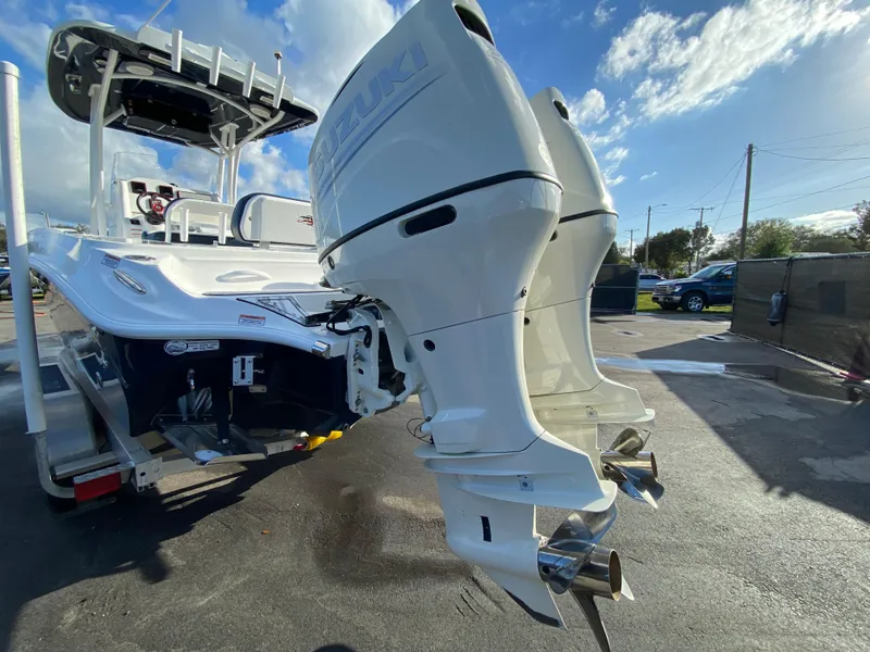 Slide: The Image of 2020 Glasstream 280 Pro-XS boat with dual outboard motors, parked outdoors. - 6