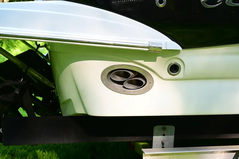 Slide: The Image of 2015 Crownline 236 boat exhaust detail, featuring dual exhaust ports and sleek design. - 20