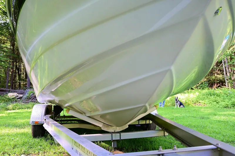 Slide: The Image of 2015 Crownline 236 boat on trailer, parked on grass. - 21