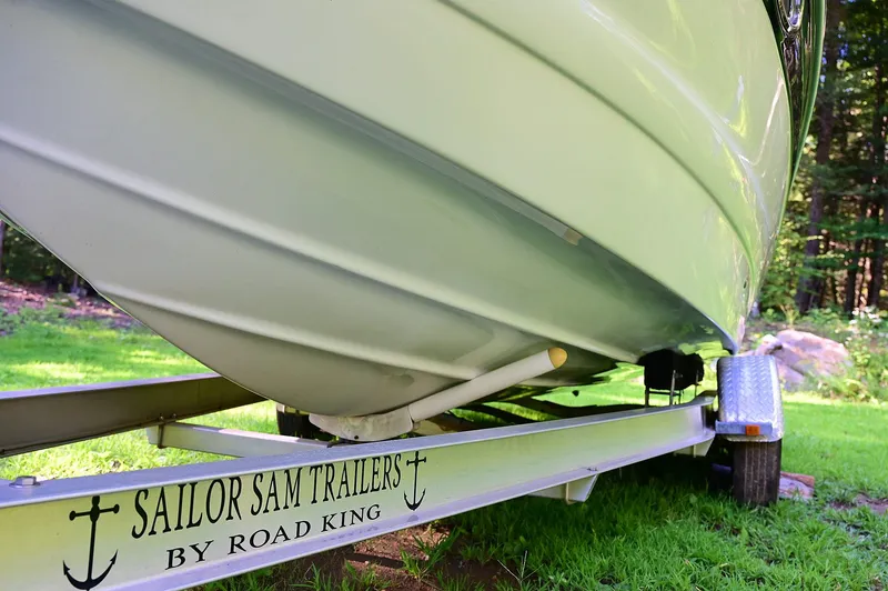 Slide: The Image of 2015 Crownline 236 boat on Sailor Sam trailer by Road King, parked on grass. - 22