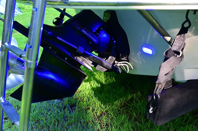 Slide: The Image of 2015 Crownline 236 boat stern with MerCruiser outdrive on grass. - 25