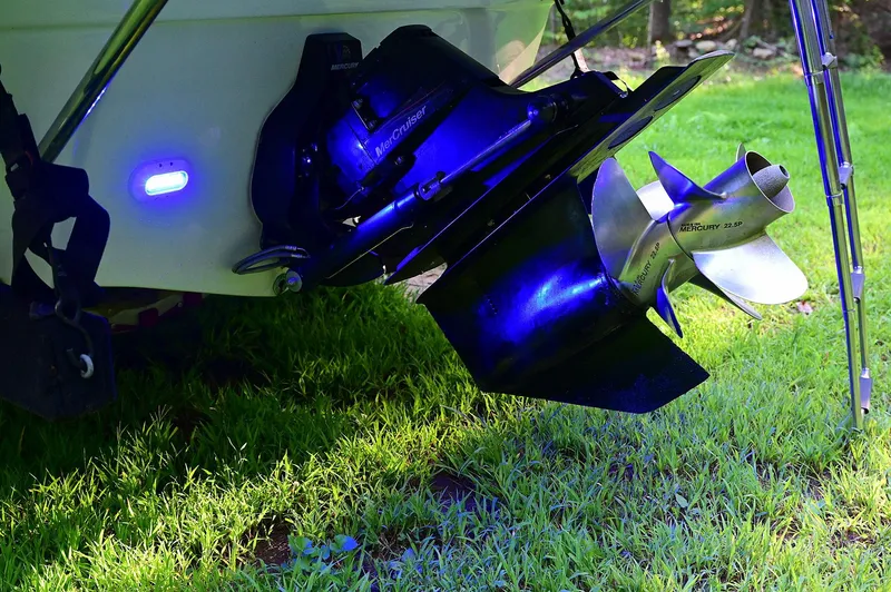 Slide: The Image of Crownline 236 boat propeller and stern drive, illuminated, on grass. - 27