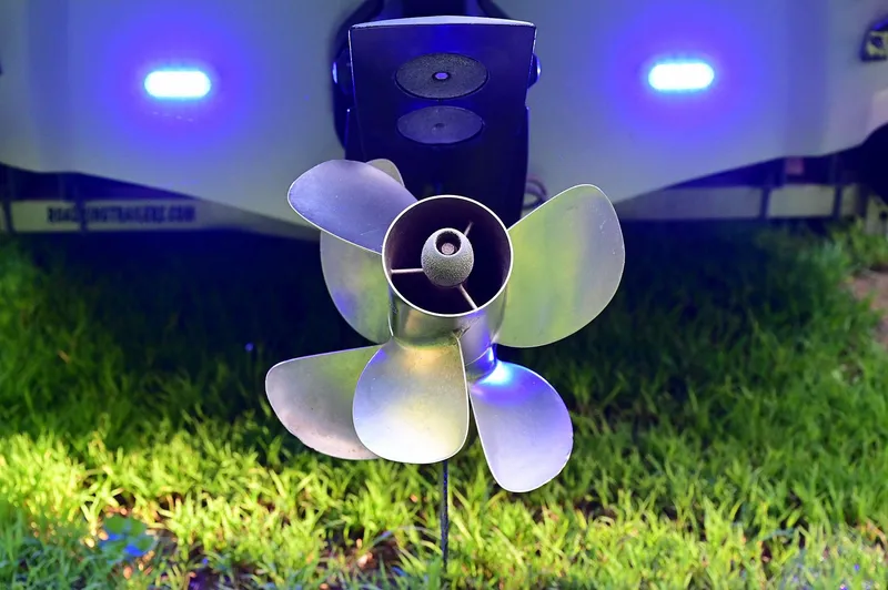 Slide: The Image of Propeller of 2015 Crownline 236 boat with blue LED lights, on grass. - 30