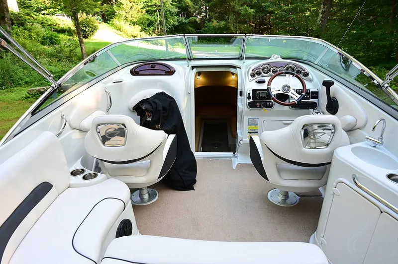 Slide: The Image of Interior of a 2015 Crownline 236 boat with modern seating and dashboard. - 33