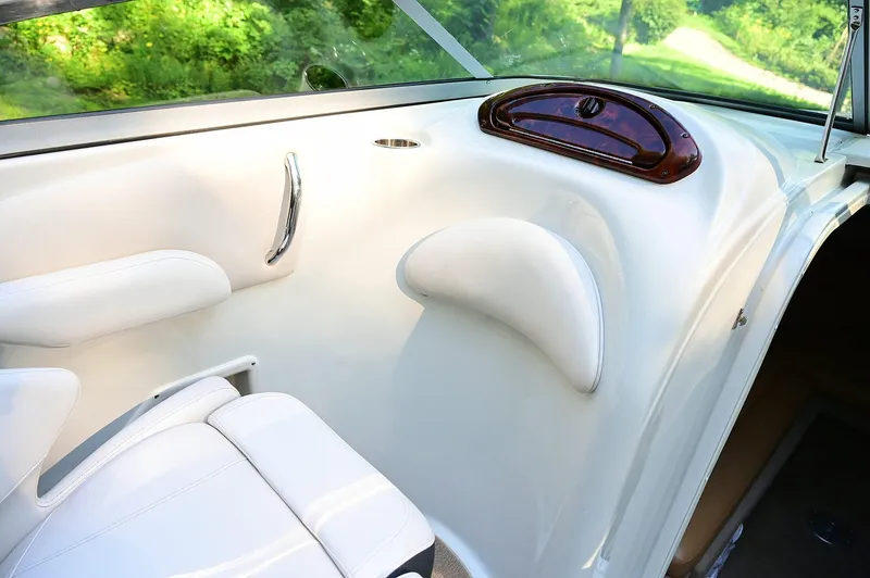 Slide: The Image of Interior of a 2015 Crownline 236 boat, featuring white seating and sleek design elements. - 34