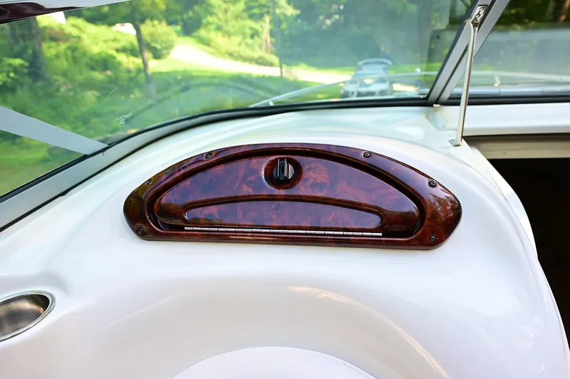 Slide: The Image of 2015 Crownline 236 boat dashboard with wood trim detail. - 35