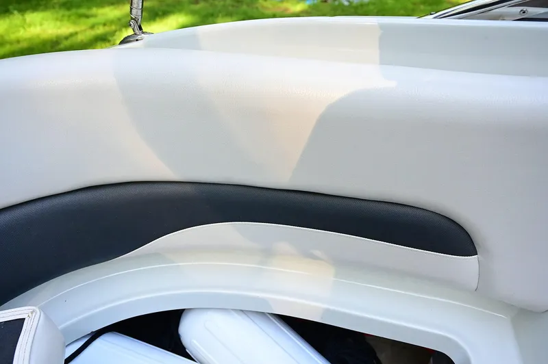 Slide: The Image of Interior detail of a 2015 Crownline 236 boat, featuring sleek upholstery design. - 37