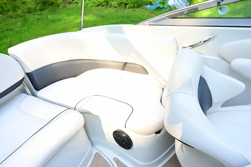 Slide: The Image of Interior of 2015 Crownline 236 boat with white seating and speaker. - 38
