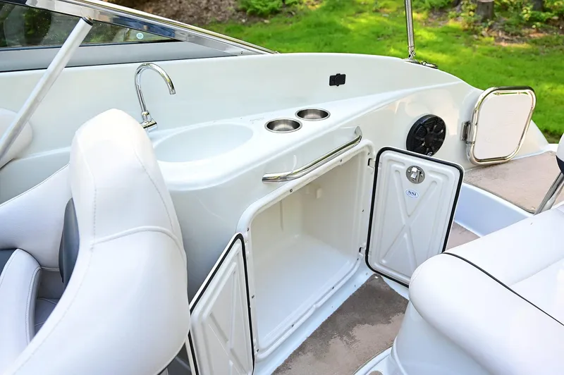 Slide: The Image of 2015 Crownline 236 boat interior with sink, storage, and seating. - 39