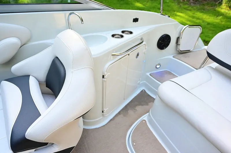Slide: The Image of 2015 Crownline 236 boat interior with white seating and built-in amenities. - 40