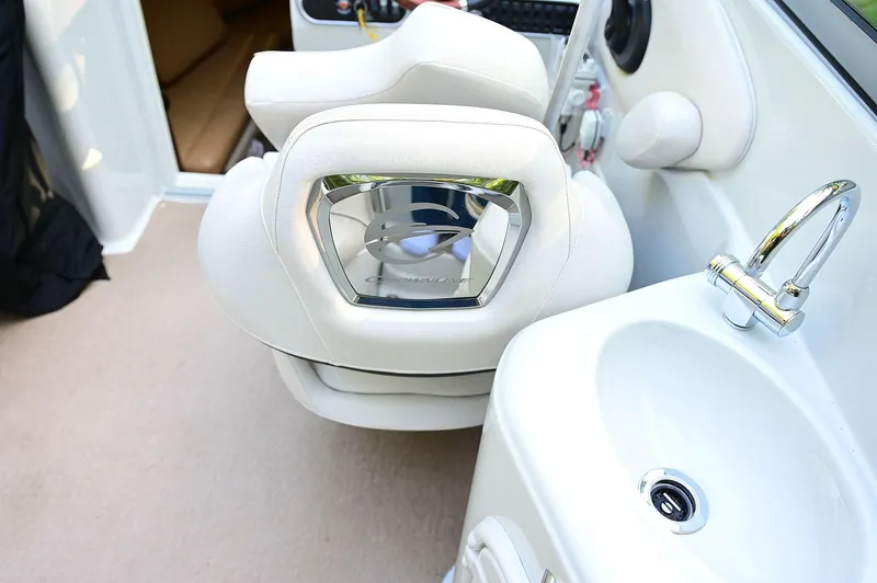 Slide: The Image of 2015 Crownline 236 boat interior with white seating and sink. - 41