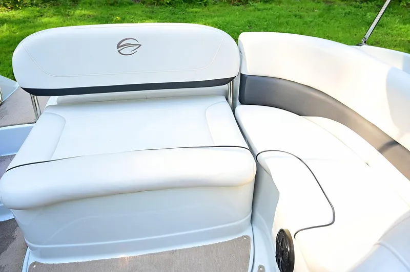 Slide: The Image of 2015 Crownline 236 boat interior with white cushioned seating and elegant design. - 42