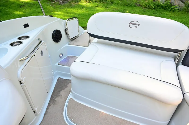 Slide: The Image of 2015 Crownline 236 boat interior with white seating and cup holders. - 43