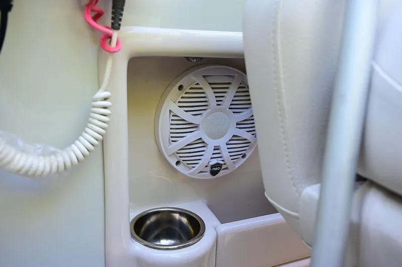 Slide: The Image of Speaker and cup holder in 2015 Crownline 236 boat interior. - 47