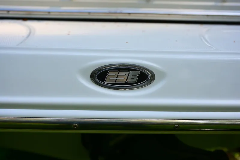 Slide: The Image of 2015 Crownline 236 boat emblem on white surface. - 48