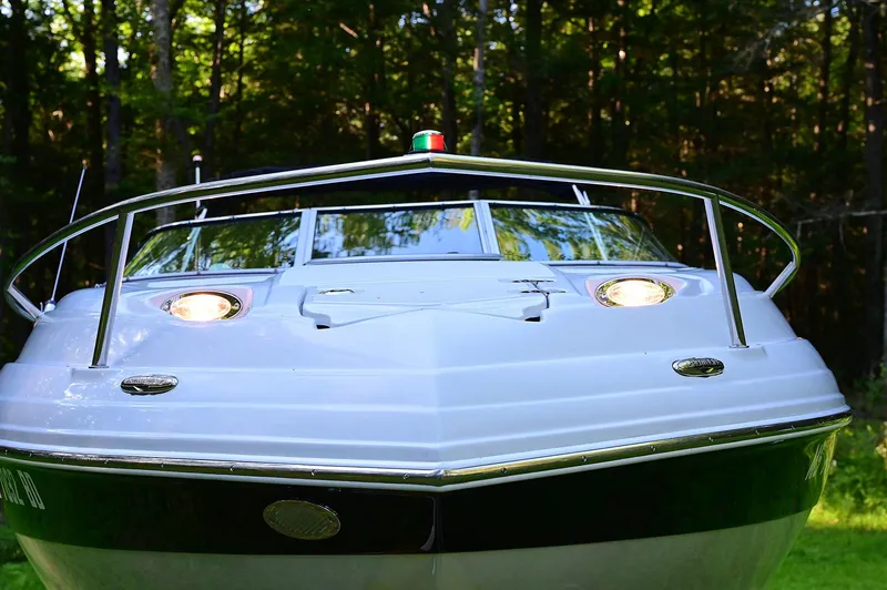 Slide: The Image of 2015 Crownline 236 boat front view in a wooded area. - 8