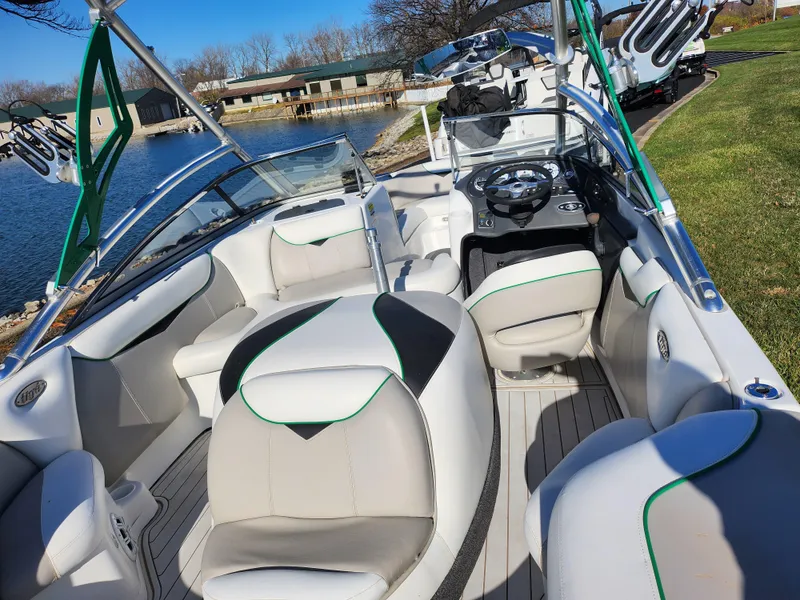 Slide: The Image of 2007 Tigé 22i boat interior with sleek seating and modern design by a lakeside. - 10