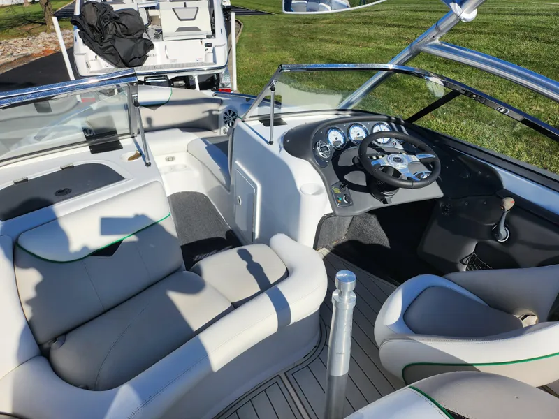 Slide: The Image of 2007 Tigé 22i boat interior with sleek dashboard and comfortable seating. - 11