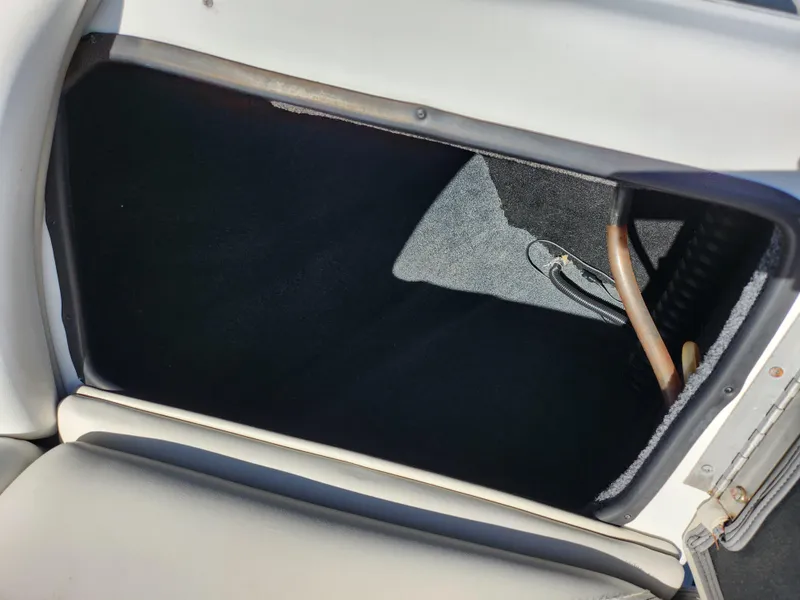 Slide: The Image of Open storage compartment in 2007 Tigé 22i boat interior. - 14