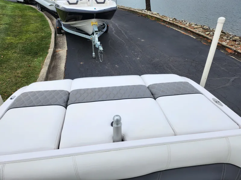 Slide: The Image of 2004 Supra Launch SSV boat on trailer by lakeside road. - 18