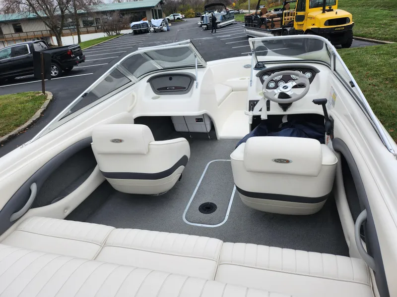 Slide: The Image of 2004 Chaparral 180 SSi boat interior with white seating and steering wheel. - 11