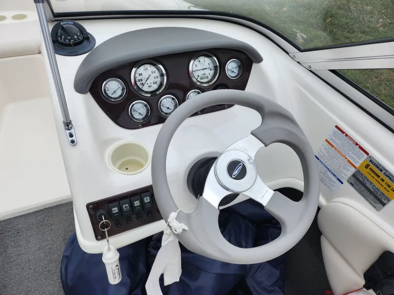 Slide: The Image of 2004 Chaparral 180 SSi boat dashboard with steering wheel and gauges. - 14