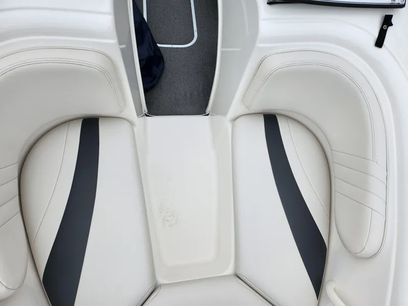 Slide: The Image of 2004 Chaparral 180 SSi boat interior with white and gray seating. - 17