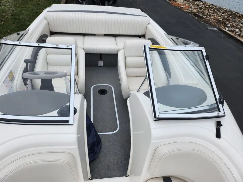 Slide: The Image of 2004 Chaparral 180 SSi boat interior with white seating and open windshield. - 18