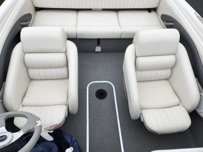 Slide: The Image of 2004 Chaparral 180 SSi boat interior with white leather seats and gray carpet. - 19