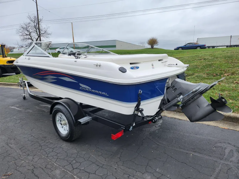 Slide: The Image of 2004 Chaparral 180 SSi boat on trailer, parked outdoors on a cloudy day. - 3