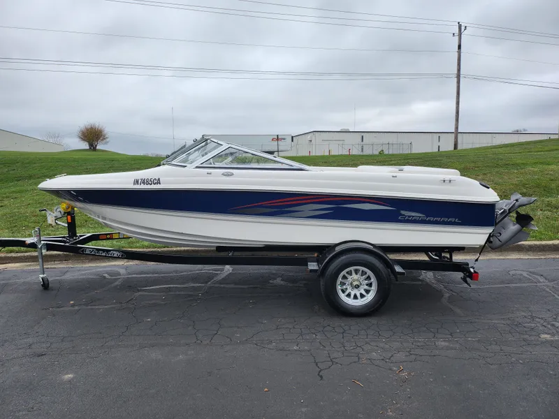 Slide: The Image of 2004 Chaparral 180 SSi boat on trailer, parked outdoors on paved surface. - 4