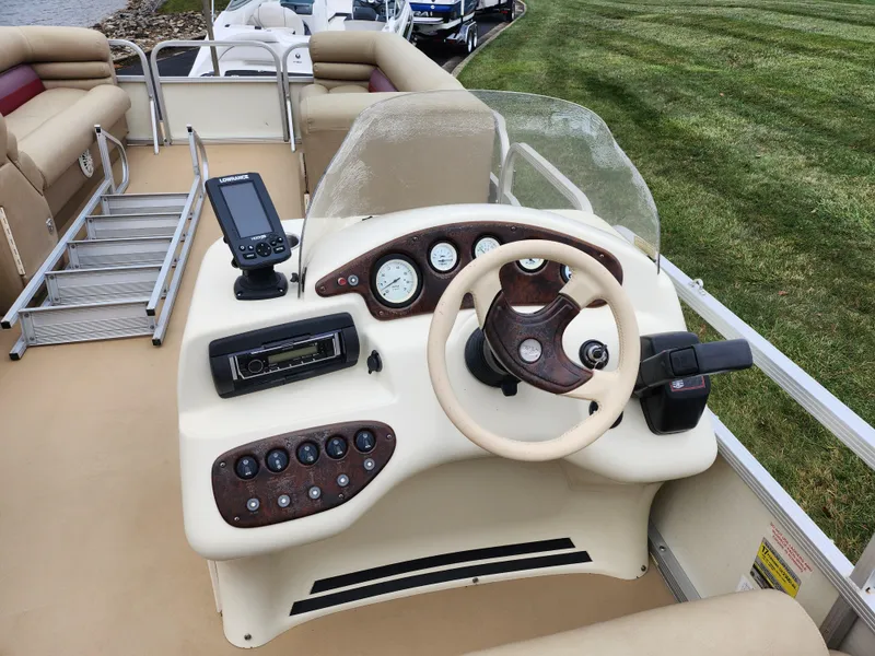 Slide: The Image of Bennington 2580LX 2000 boat dashboard with steering wheel and control panel. - 21