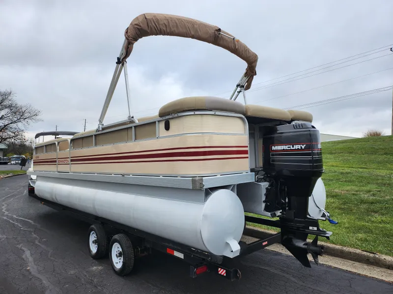 Slide: The Image of 2000 Bennington 2580LX pontoon boat with Mercury outboard motor on trailer. - 3