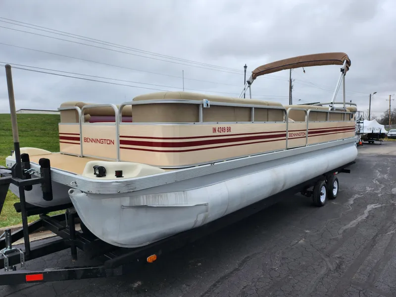 Slide: The Image of 2000 Bennington 2580LX pontoon boat on trailer, beige with red stripes. - 5