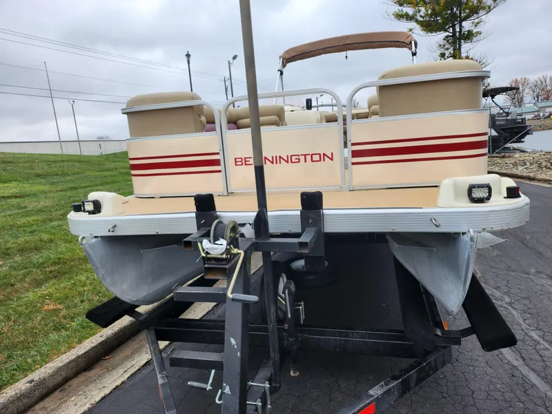 Slide: The Image of 2000 Bennington 2580LX pontoon boat on trailer, rear view, parked outdoors. - 6