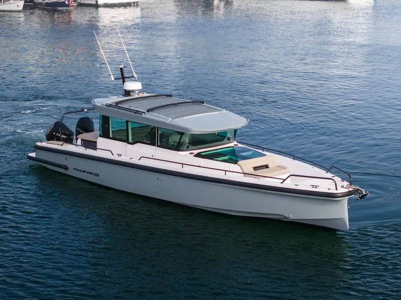 Slide: The Image of 2023 Axopar 37 Aft Cabin boat cruising on calm water. - 10