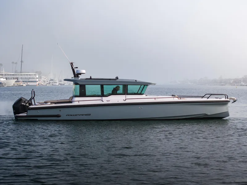 Slide: The Image of 2023 Axopar 37 Aft Cabin boat on calm water, side view. - 11