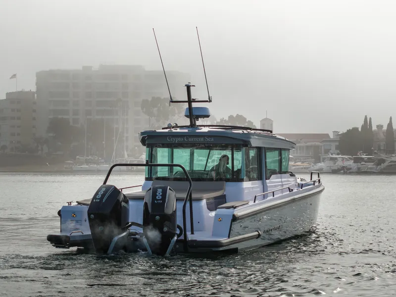 Slide: The Image of 2023 Axopar 37 Aft Cabin boat on misty water near marina. - 14