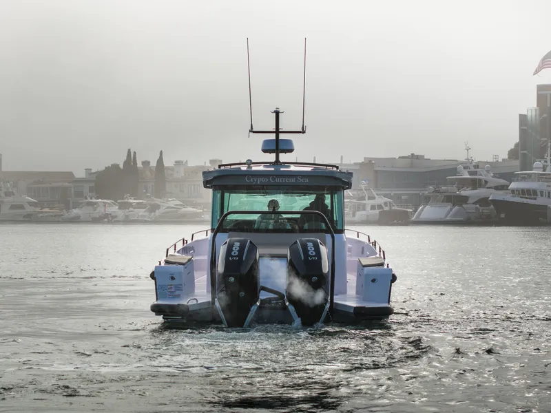 Slide: The Image of 2023 Axopar 37 Aft Cabin boat cruising in a marina with twin engines. - 15