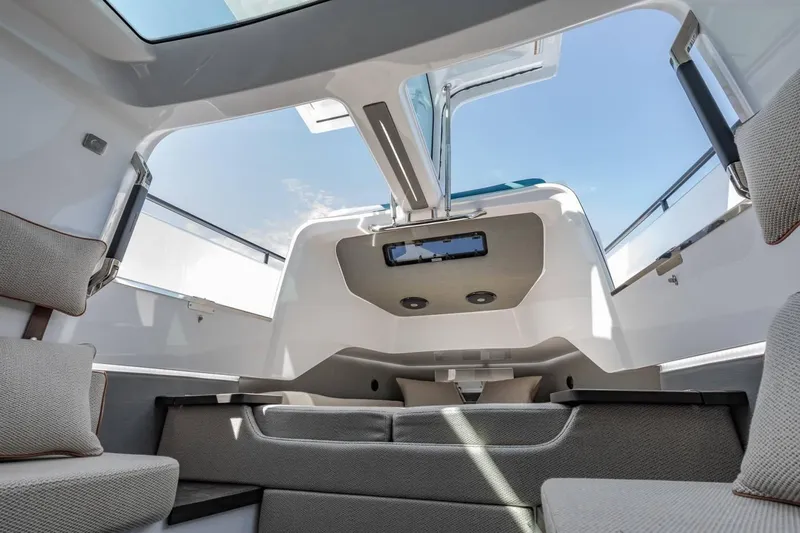 Slide: The Image of Interior view of 2023 Axopar 37 Aft Cabin with skylight and modern seating. - 18
