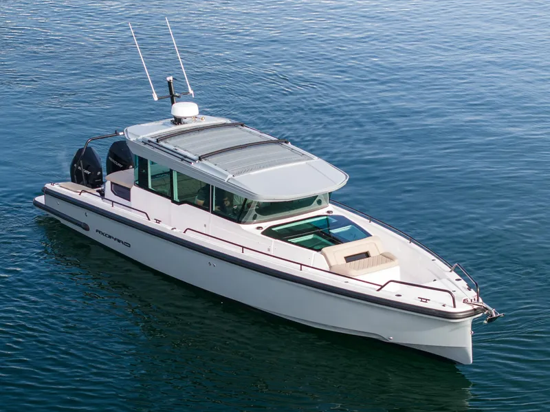 Slide: The Image of 2023 Axopar 37 Aft Cabin boat on calm water, featuring sleek design and modern amenities. - 2