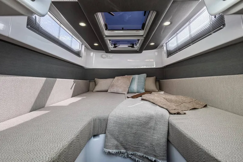 Slide: The Image of Luxurious interior of 2023 Axopar 37 Aft Cabin with cozy seating and skylight. - 21