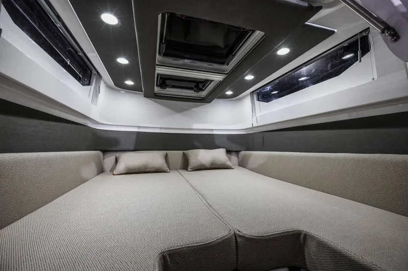 Slide: The Image of Luxurious interior of 2023 Axopar 37 Aft Cabin with modern lighting and comfortable bedding. - 23