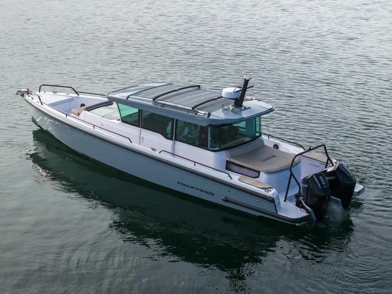 Slide: The Image of 2023 Axopar 37 Aft Cabin boat on calm water, side view. - 5