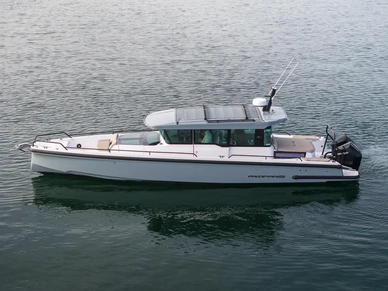 Slide: The Image of 2023 Axopar 37 Aft Cabin boat on calm water. - 6