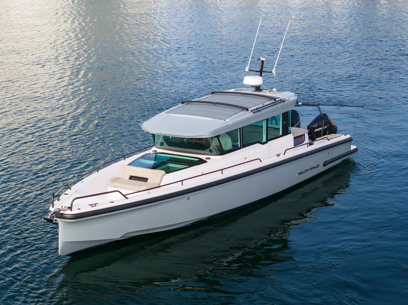 Slide: The Image of 2023 Axopar 37 Aft Cabin boat on calm water. - 7