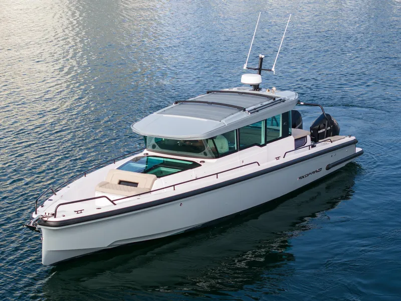 Slide: The Image of 2023 Axopar 37 Aft Cabin boat cruising on calm water. - 8