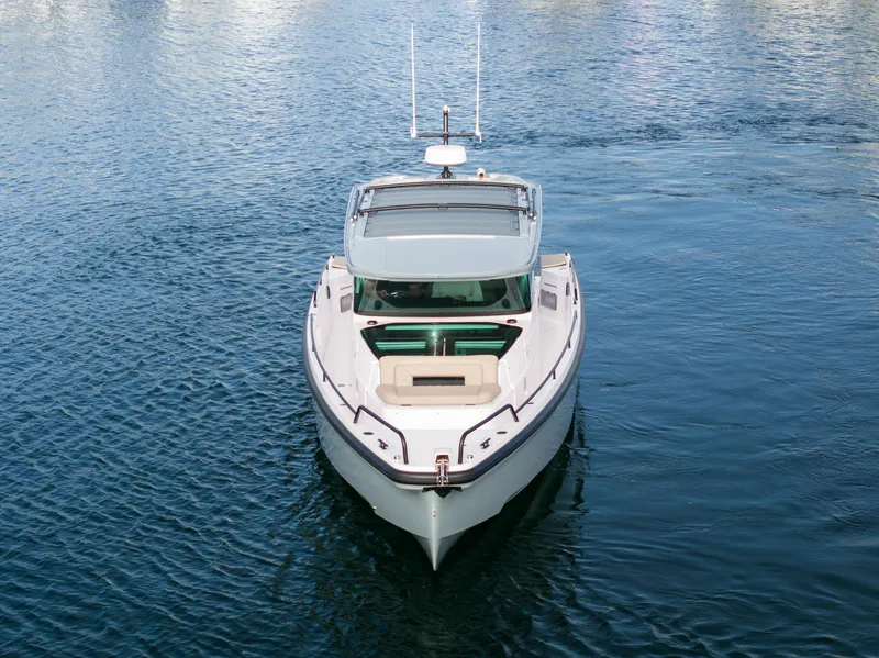 Slide: The Image of 2023 Axopar 37 Aft Cabin boat cruising on calm blue water. - 9